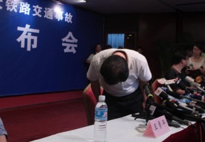 Ministry of Rail spokesperson Wang Yongping bows to passengers